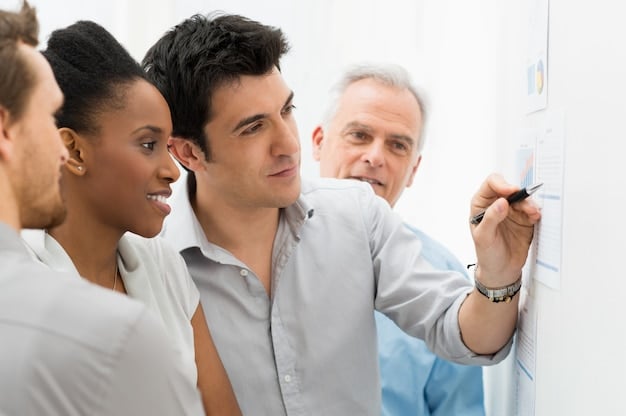 A high-angle shot of a Spanish entrepreneur leading a team meeting, using a whiteboard to illustrate key strategic points. The team members are engaged and actively participating, showcasing effective leadership and teamwork.