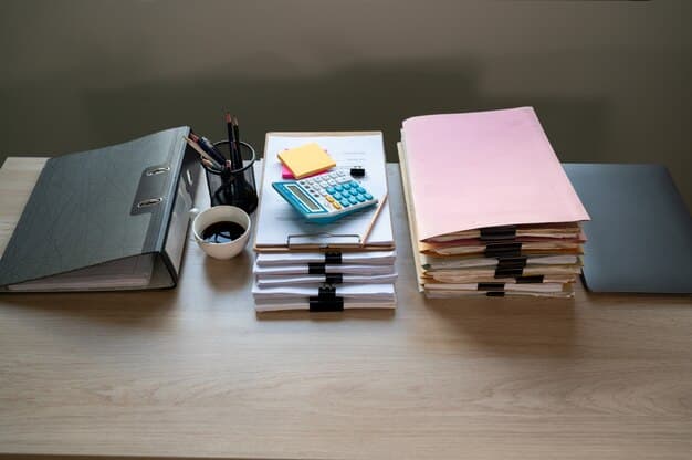 A close-up shot of various documents neatly arranged on a desk, including a business plan, ID cards, financial statements, and application forms, symbolizing the required documentation for government support programs.