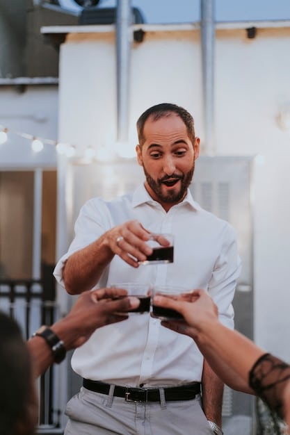 Image of a Mexican entrepreneur exchanging business cards with a potential investor during a networking event in Guadalajara.
