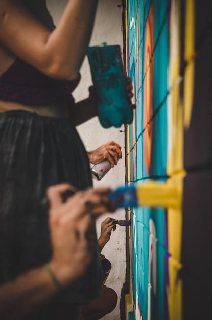 A close-up of a street artist in Mexico City creating a stunning mural as part of a guerrilla marketing campaign for a local coffee shop. The artwork incorporates elements of Mexican folklore and the coffee shop's logo.