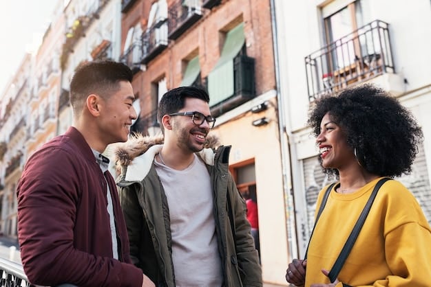 A diverse group of young adults in a trendy neighborhood in Guadalajara, Mexico, are laughing and engaging with a unique piece of guerrilla marketing that offers a free sample of a new organic snack product.