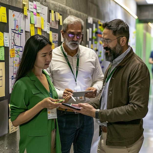 A team of diverse workers in a Mexican company looking at a dashboard showing environmental performance metrics, with charts and graphs indicating progress towards sustainability goals.