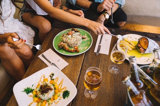 A long table set up at a restaurant showing multiple bottles of Modelo Especial beer and food, with people enjoying themselves during a celebration or gathering. Make sure the beer labels are visible.